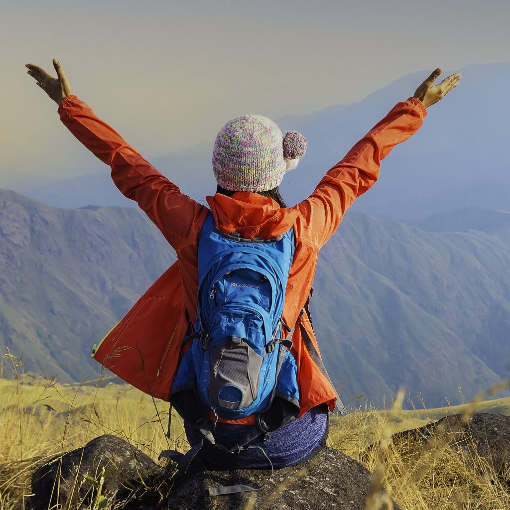 Hiker with backpack relaxing young woman hiking holiday, wild adventure.
